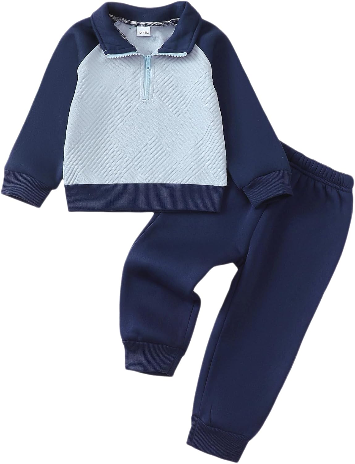 Toddler boy wearing KIMI BEAR sweatsuit playing in a park